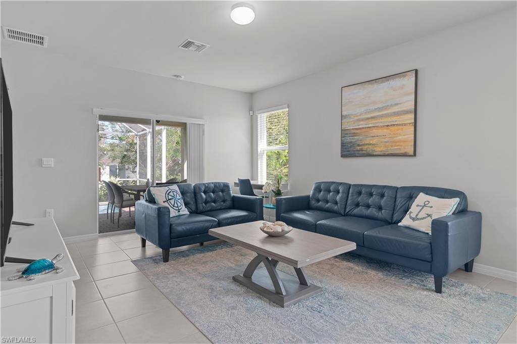 Living area featuring baseboards and light tile patterned floors