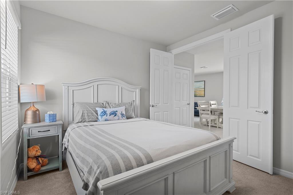 Bedroom with light colored carpet