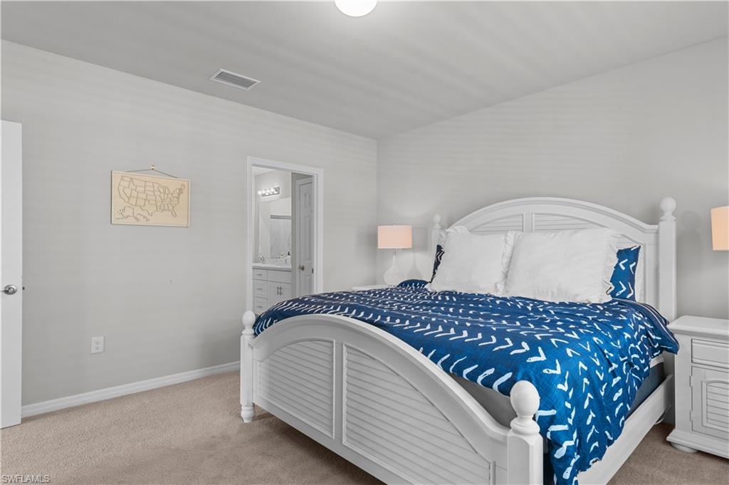 Bedroom featuring carpet floors and ensuite bath