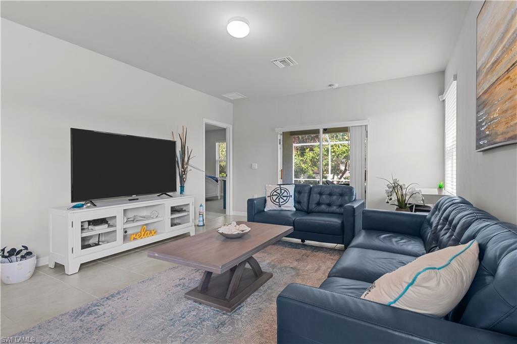Living room featuring tile patterned flooring and baseboards