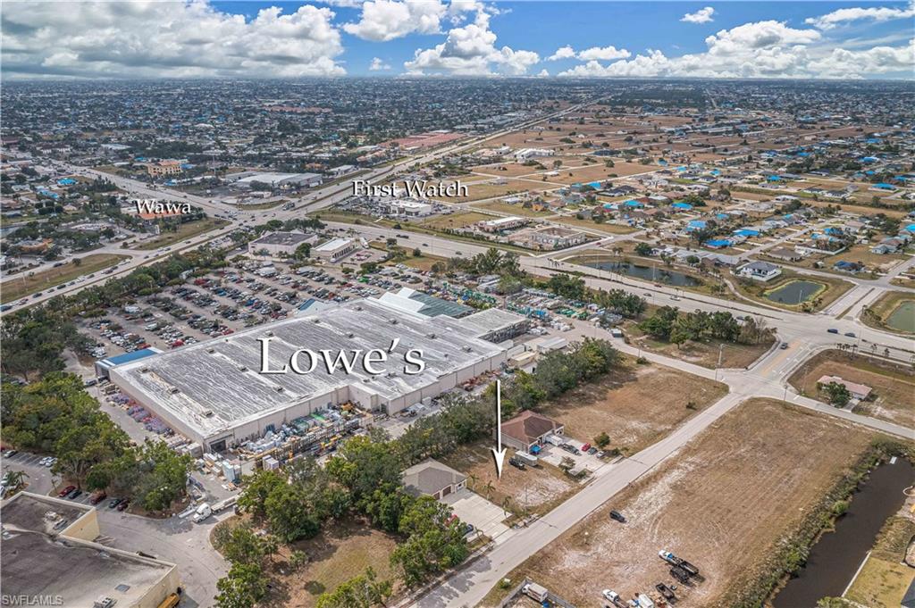 Aerial view of property and surrounding area with a large body of water