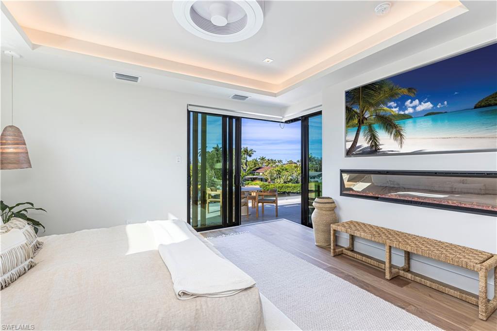 Oversized 75 inch built in tv with fireplace and sliders to rooftop sunset terrace