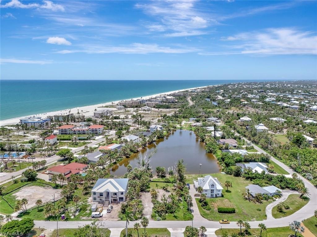 Aerial view of residential area featuring expansive beach