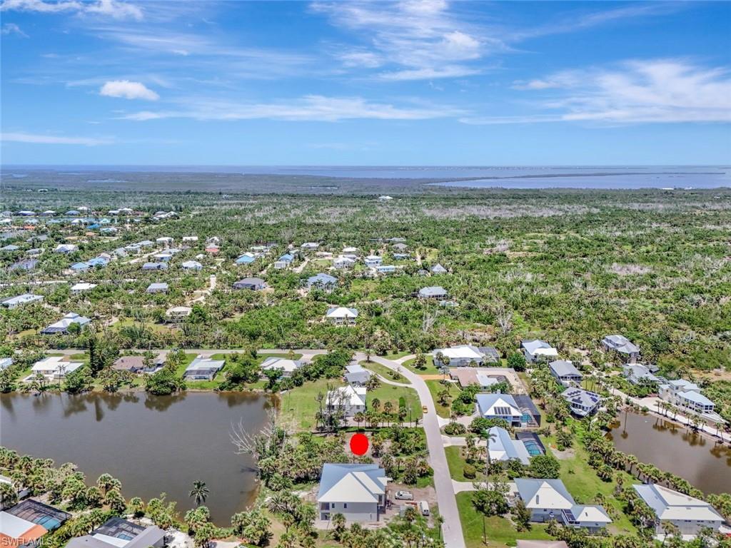 Aerial view of residential area featuring a large body of water