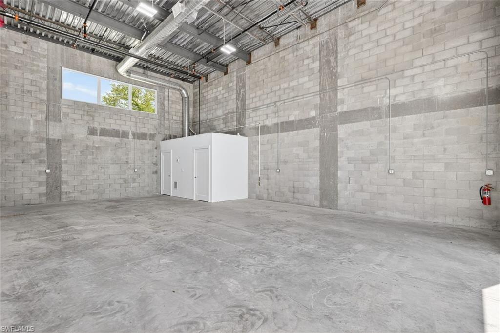 Garage with wood walls and recessed lighting