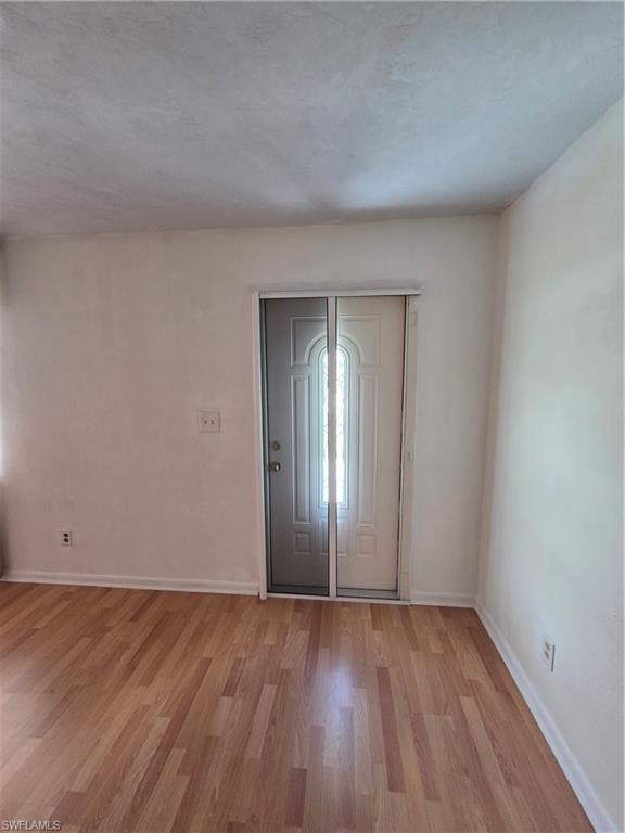 Entrance foyer featuring wood finished floors and baseboards