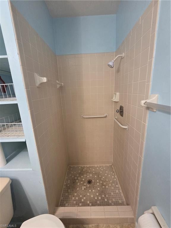 Full bath featuring toilet and a shower stall