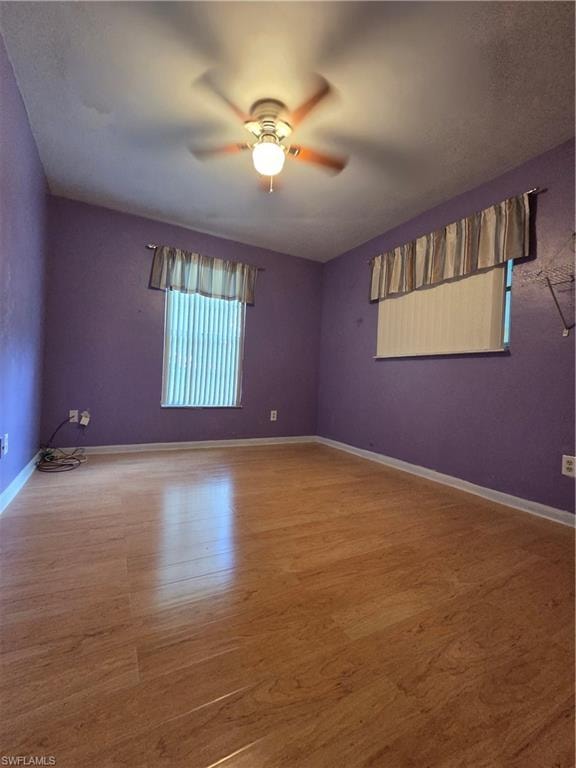 Corridor with baseboards and wood finished floors