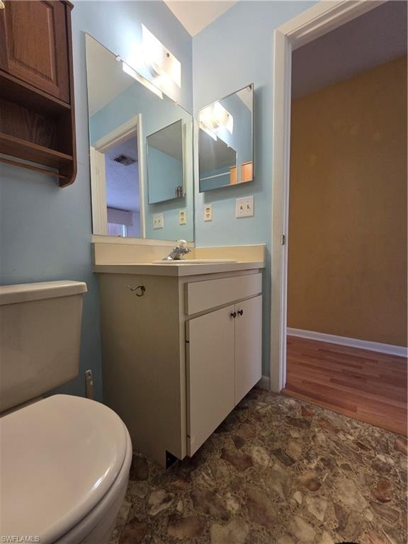 Kitchen with light countertops, light wood finished floors, white cabinets, and freestanding refrigerator