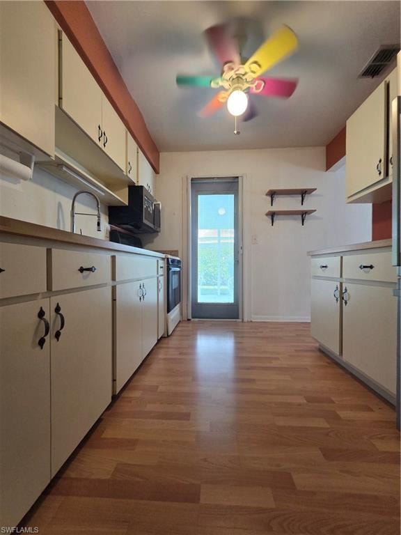 Empty room with light wood-style flooring and a ceiling fan