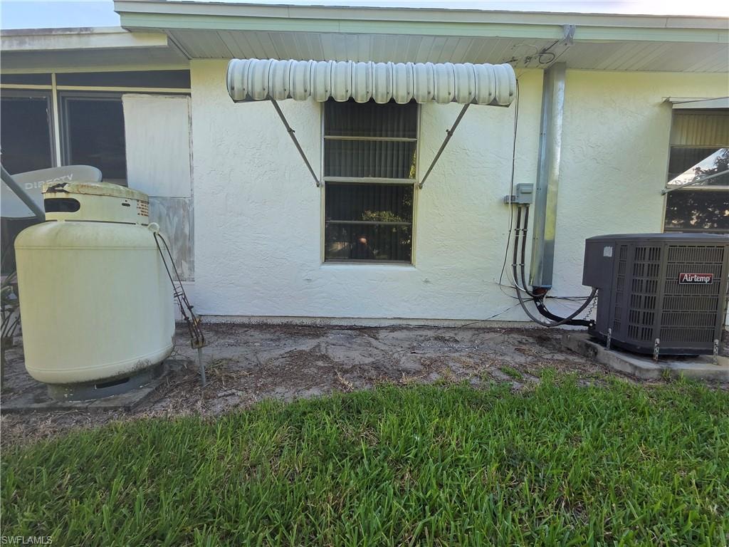 View of home's exterior featuring a central air condition unit and stucco siding