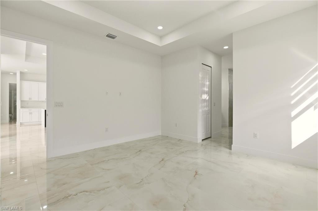 Unfurnished room featuring recessed lighting and light marble finish flooring