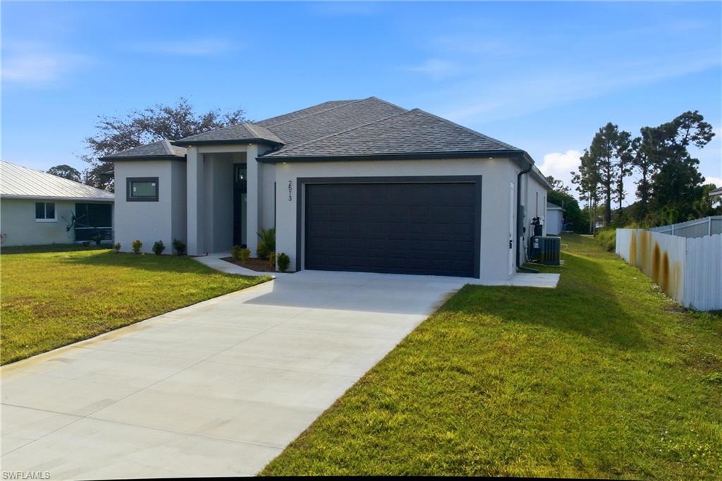 Prairie-style house featuring stucco siding, concrete driveway, roof with shingles, and an attached garage