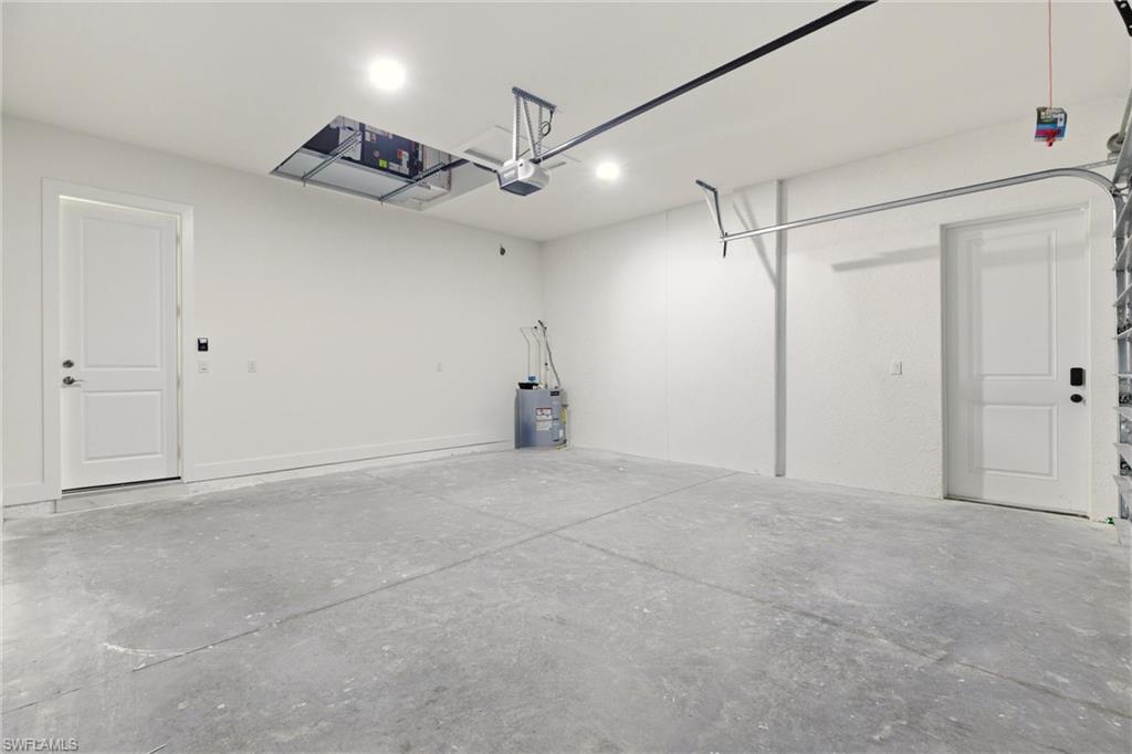 Garage with water heater and a garage door opener