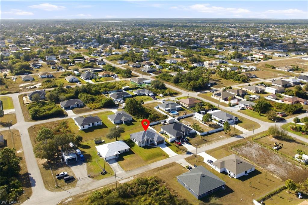 Aerial view of property's location featuring nearby suburban area