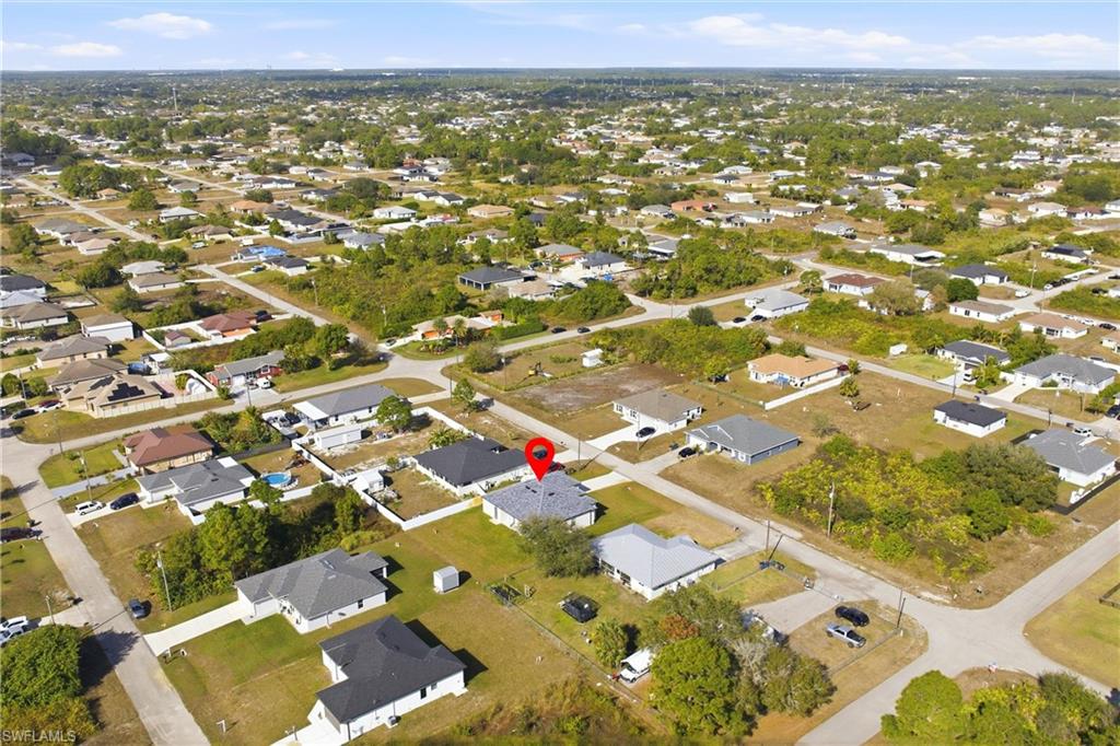 Aerial view of property's location featuring nearby suburban area