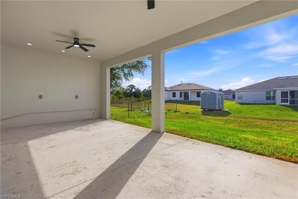 View of patio / terrace with ceiling fan and a storage unit