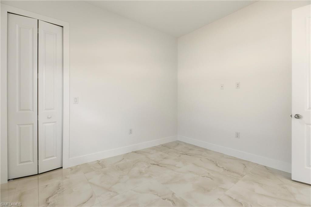 Unfurnished bedroom with baseboards