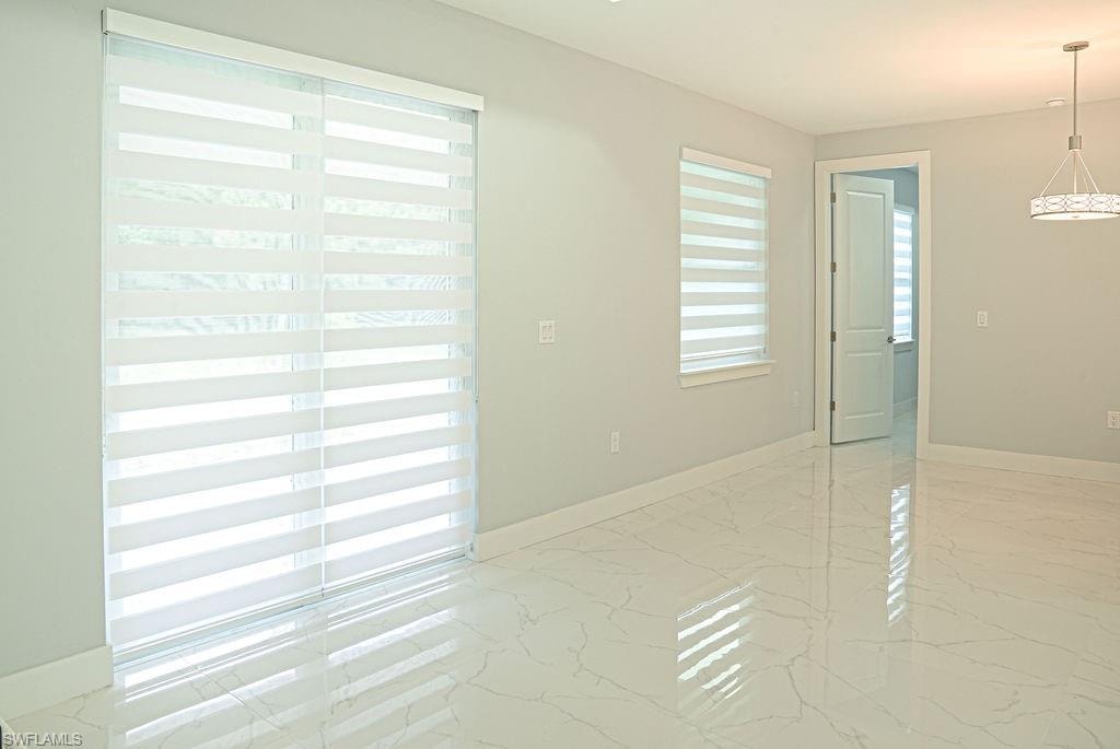 Empty room featuring light marble finish flooring
