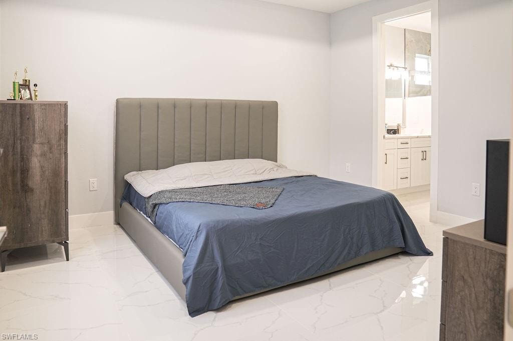 Bedroom with marble tiled floors and ensuite bath