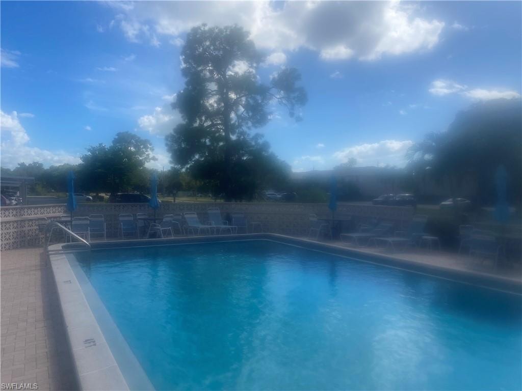 Community pool with a patio