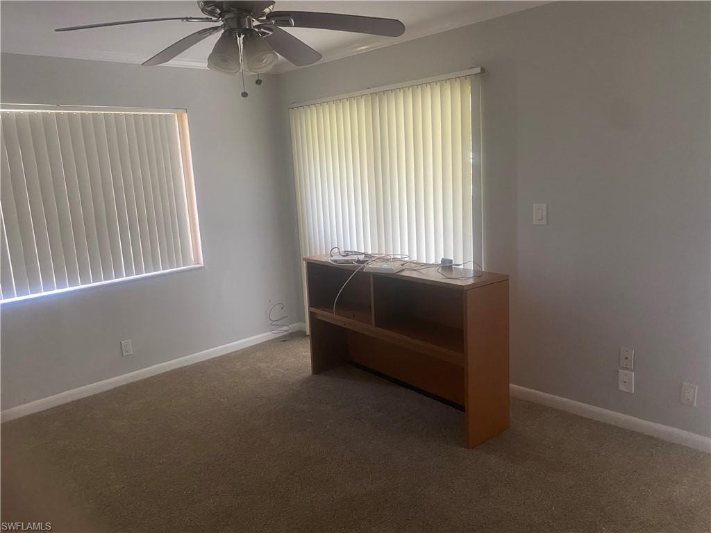 Carpeted bedroom with baseboards and a ceiling fan