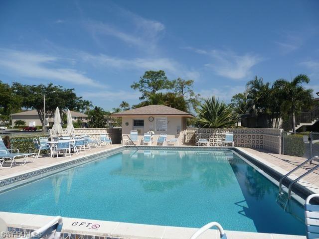 Community pool with fence and a patio