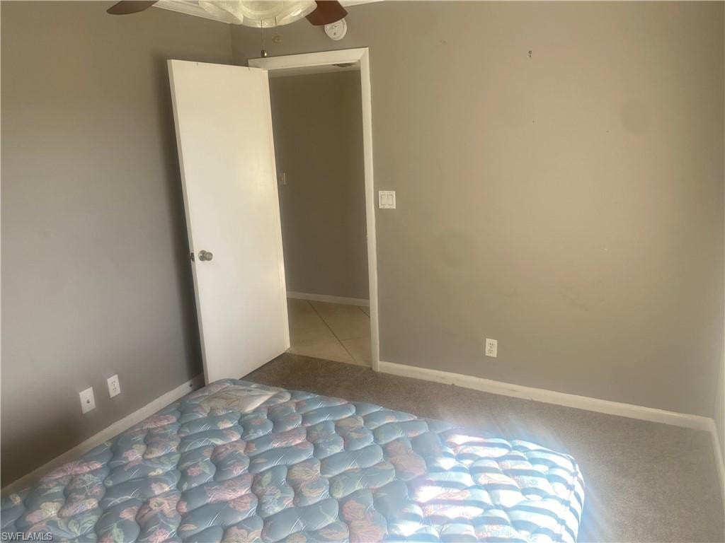Unfurnished bedroom with baseboards and ceiling fan