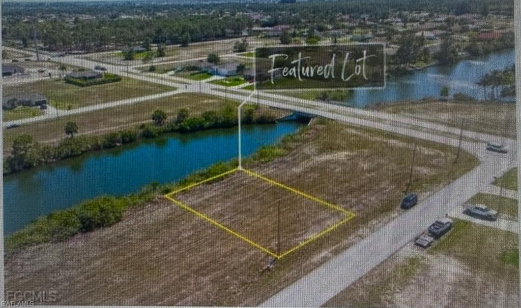 Aerial overview of property's location featuring a large body of water and property parcel outlined
