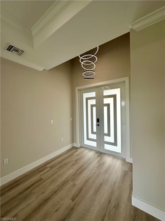 Living area with a raised ceiling, light wood finished floors, crown molding, recessed lighting, and a ceiling fan. Pictures virtually staged for illustrative purposes only