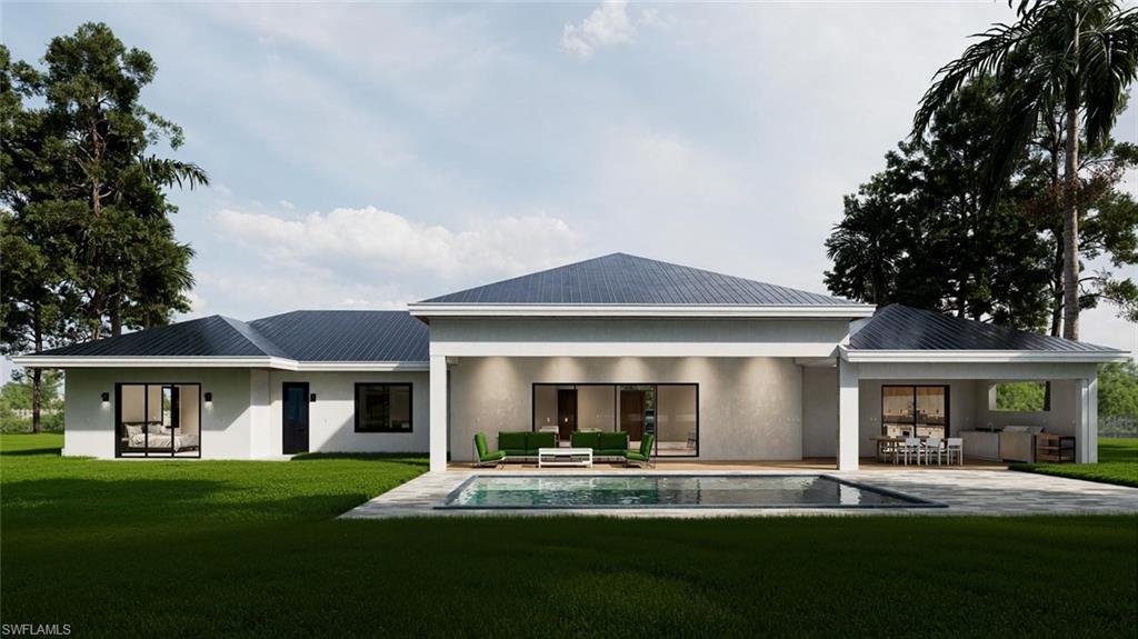 Rear view of house featuring outdoor lounge area, a patio area, stucco siding, and a yard
