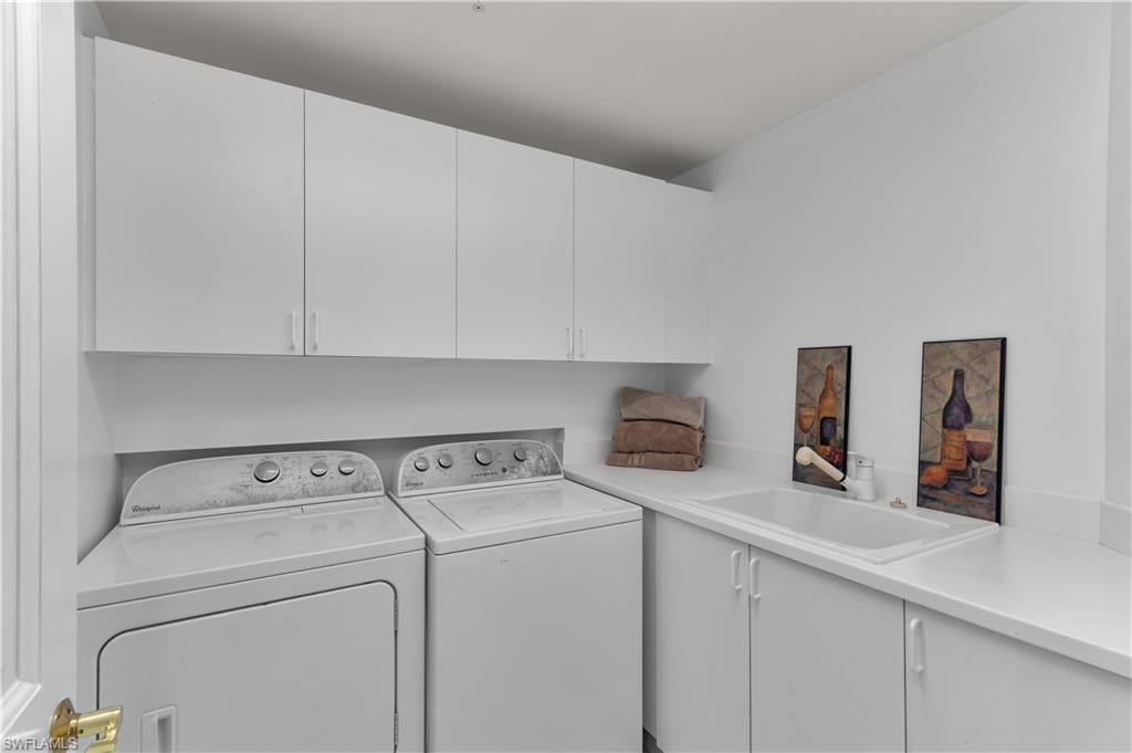 Laundry room featuring cabinet space and separate washer and dryer