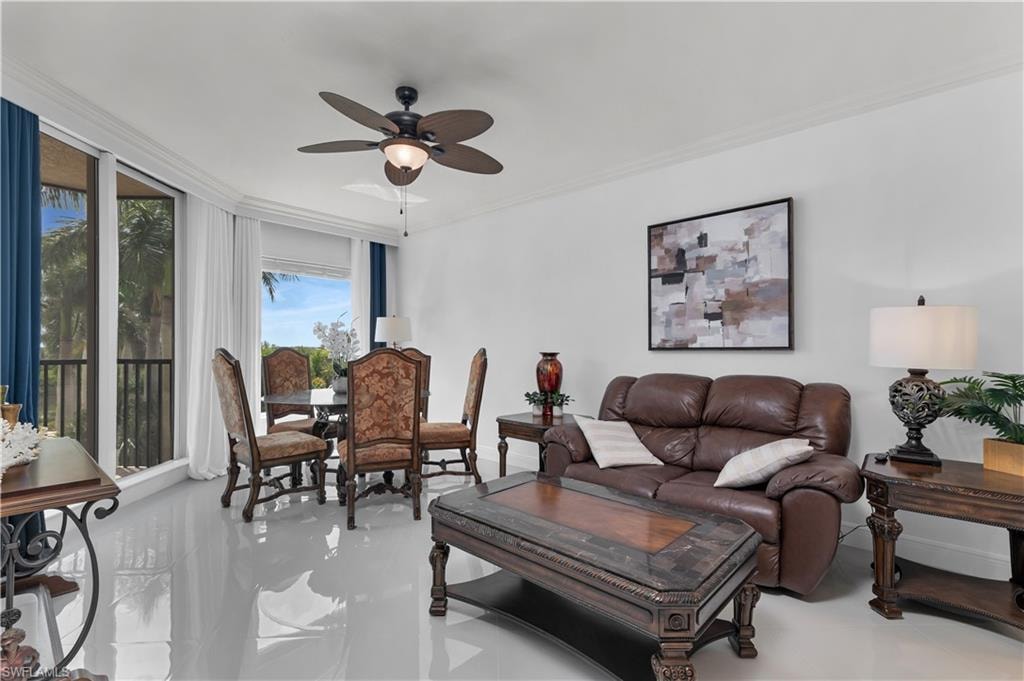 Living area featuring crown molding and a ceiling fan