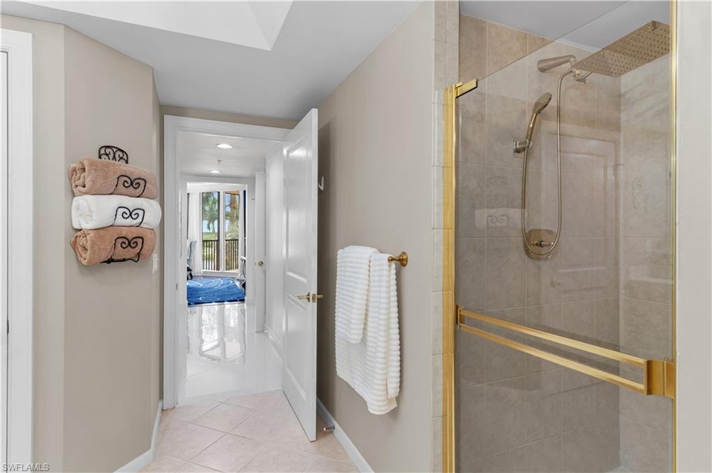 Full bathroom with tile patterned flooring and a stall shower