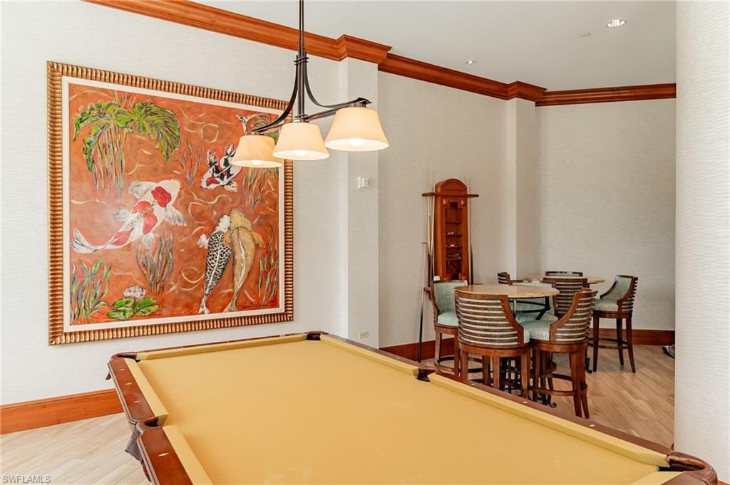 Rec room featuring wood finished floors, billiards, and crown molding