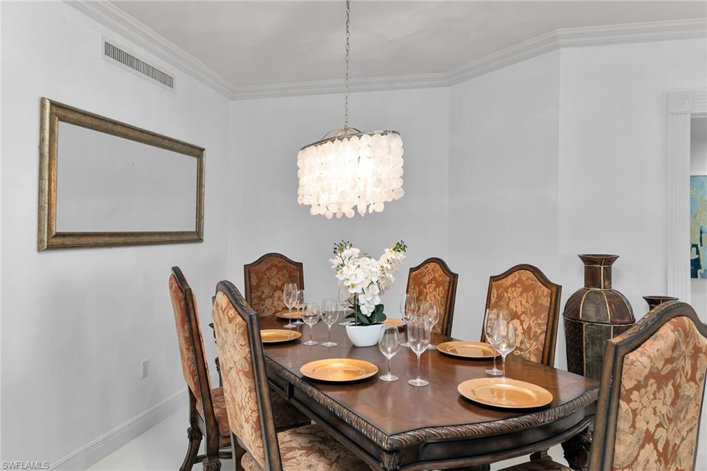 Dining room featuring crown molding and a chandelier