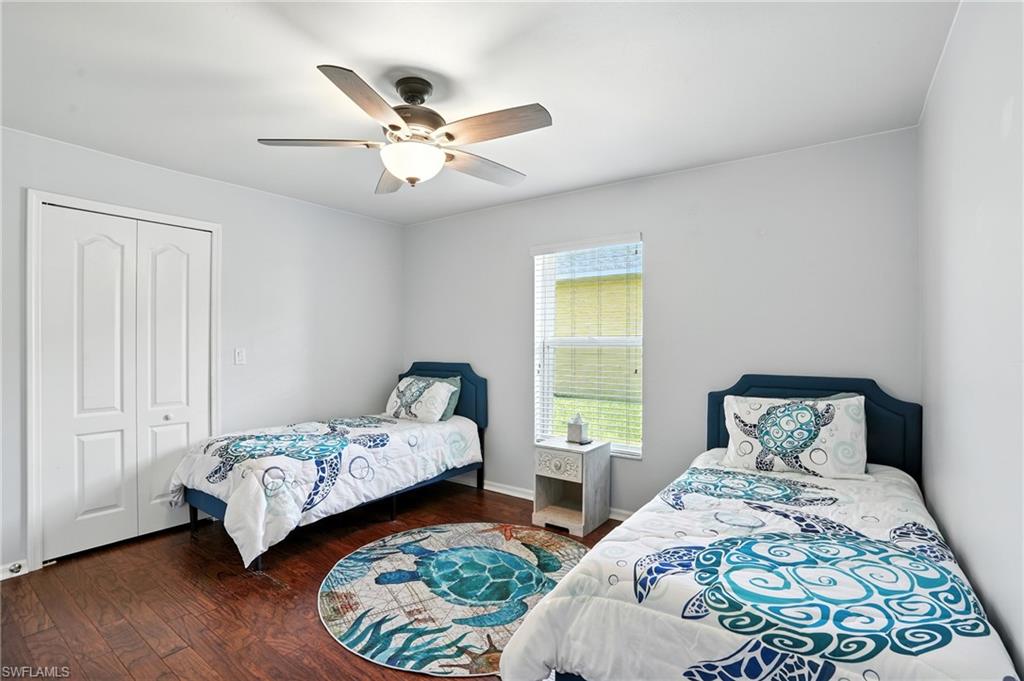 Guest bedroom 2 with walk in closet and ceiling fan
