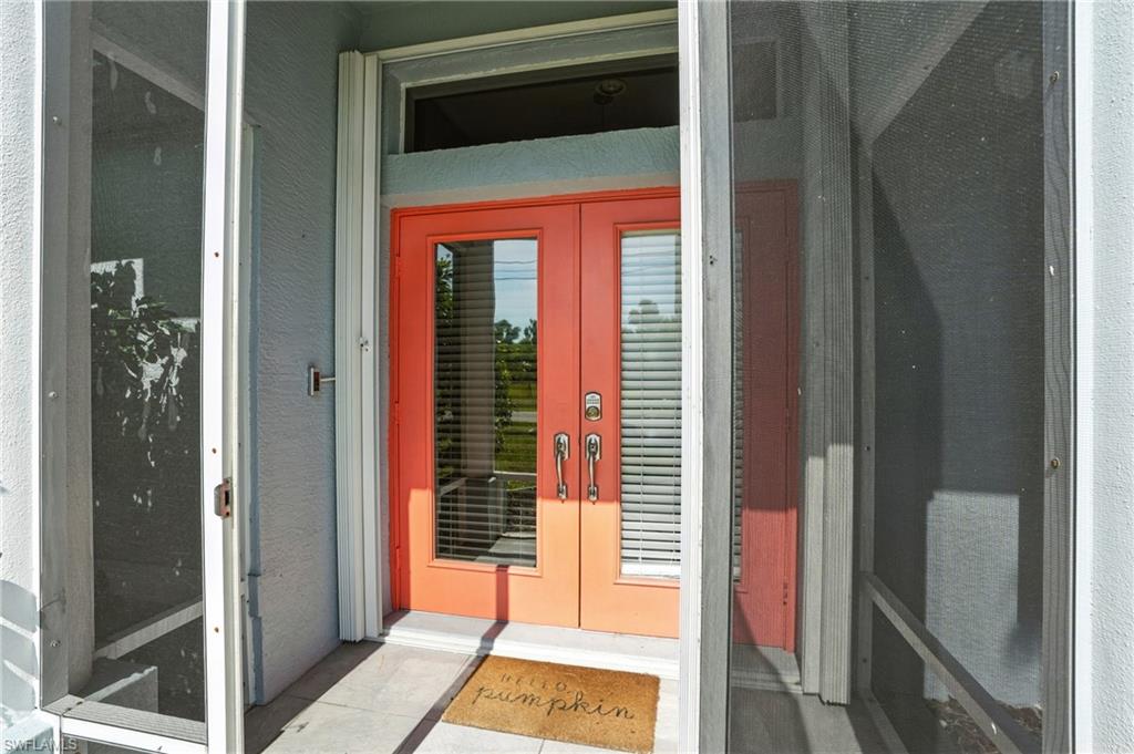 Doorway to property with painted single pane french doors