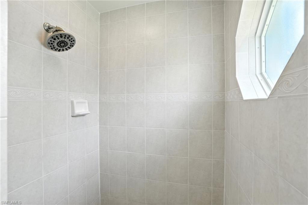 Walk in shower featuring natural light