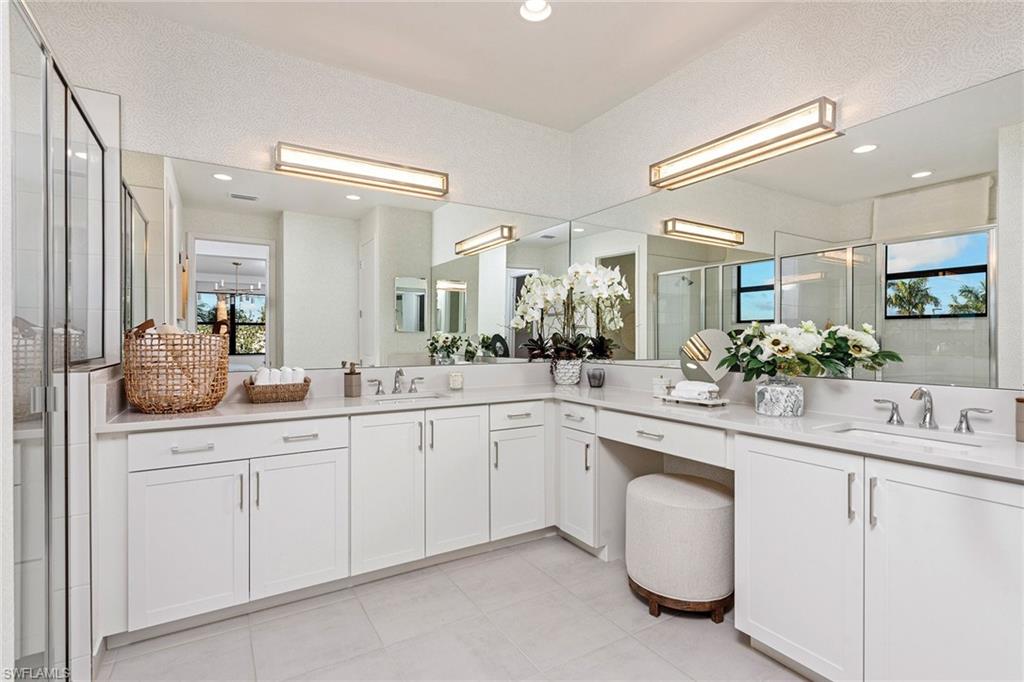 Full bath featuring vanity, a stall shower, tile patterned flooring, and recessed lighting