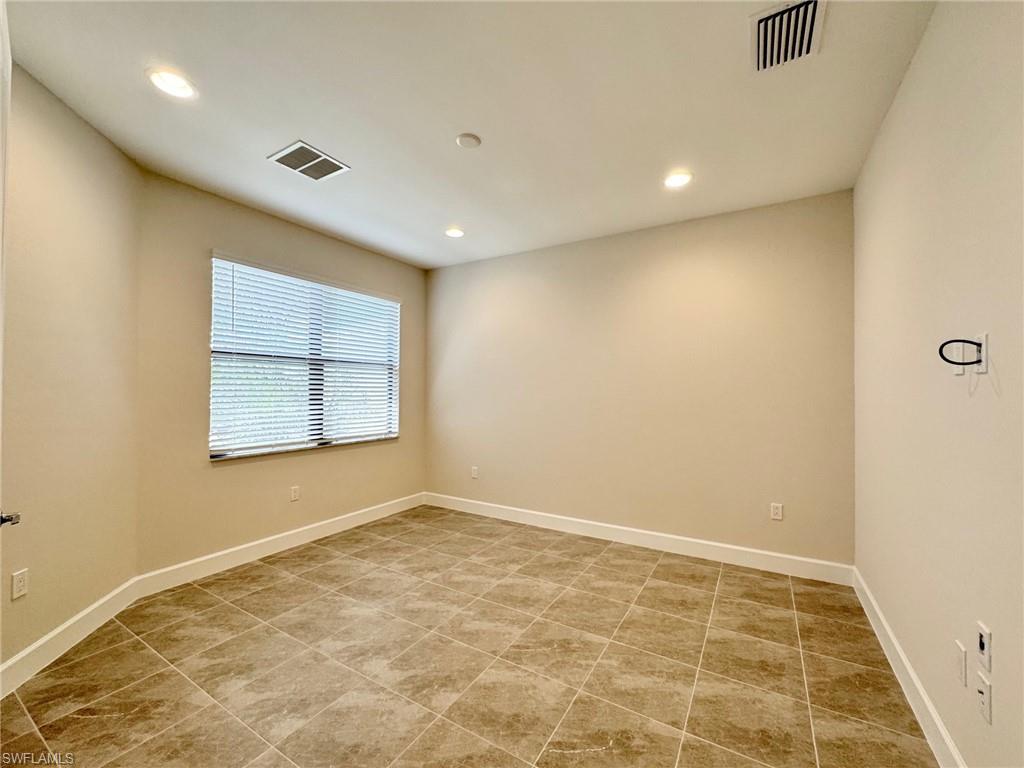 Spare room with recessed lighting and light tile patterned floors