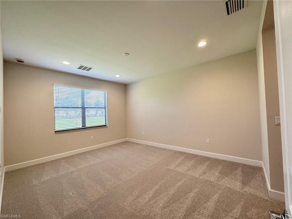Spare room featuring recessed lighting and light colored carpet