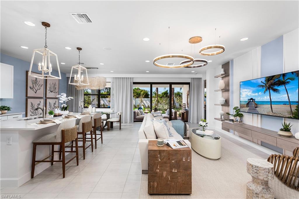 Living room with a chandelier, recessed lighting, and light tile patterned floors