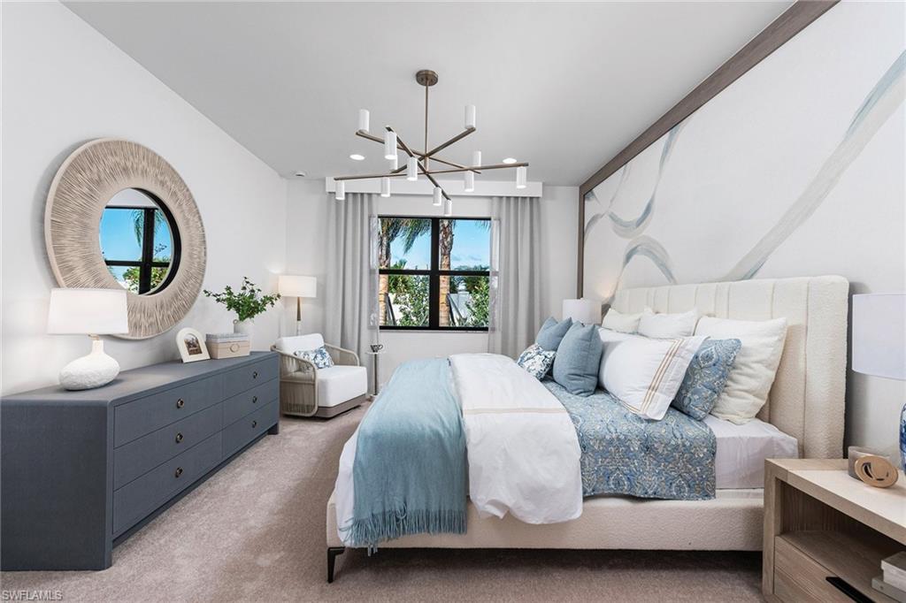 Bedroom with light colored carpet, a chandelier, and recessed lighting
