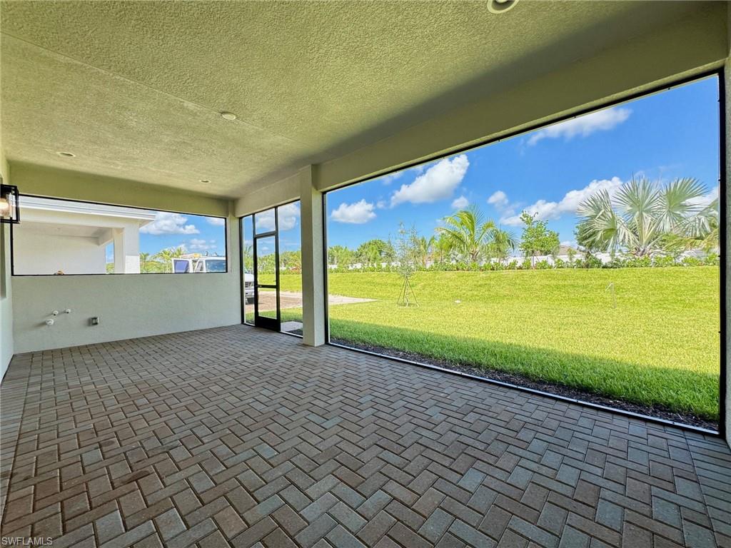 Unfurnished sunroom with a patio area