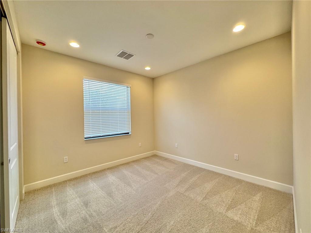 Spare room with light colored carpet and recessed lighting