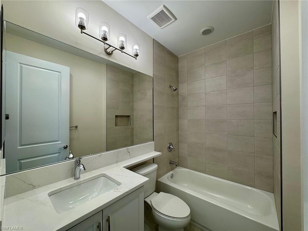 Bathroom with shower / tub combination and vanity