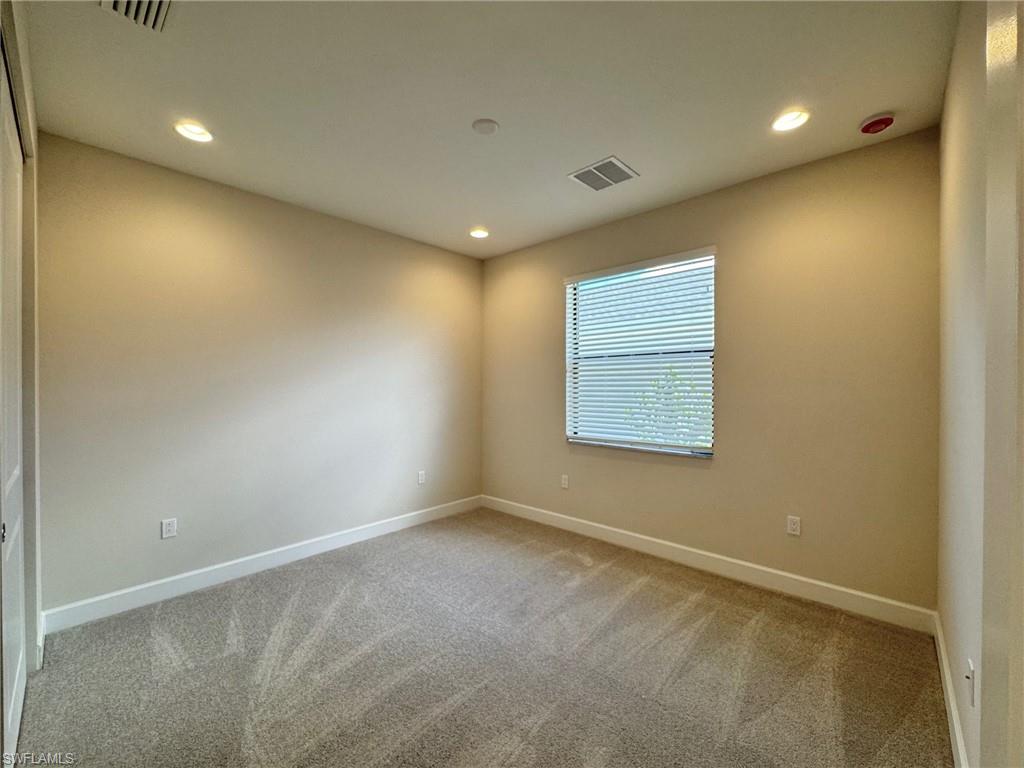 Spare room featuring light carpet and recessed lighting