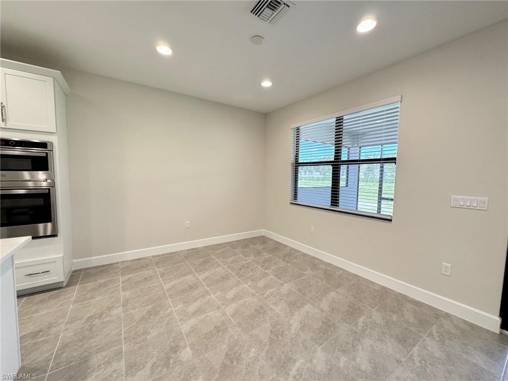 Unfurnished dining area featuring recessed lighting and light tile patterned floors