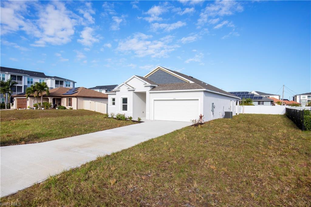 Ranch-style home with driveway, a garage, and a residential view